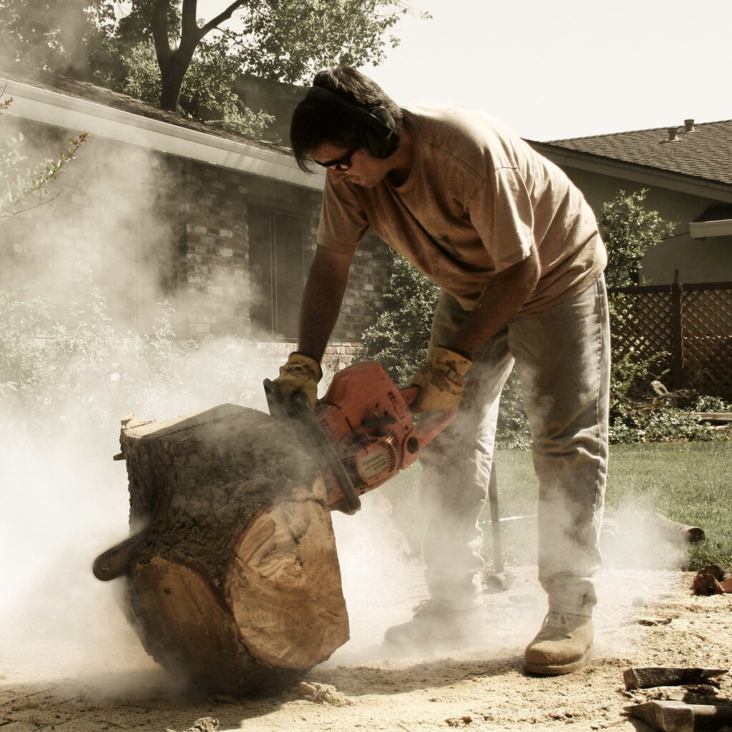 Photo of a man using a chainsaw