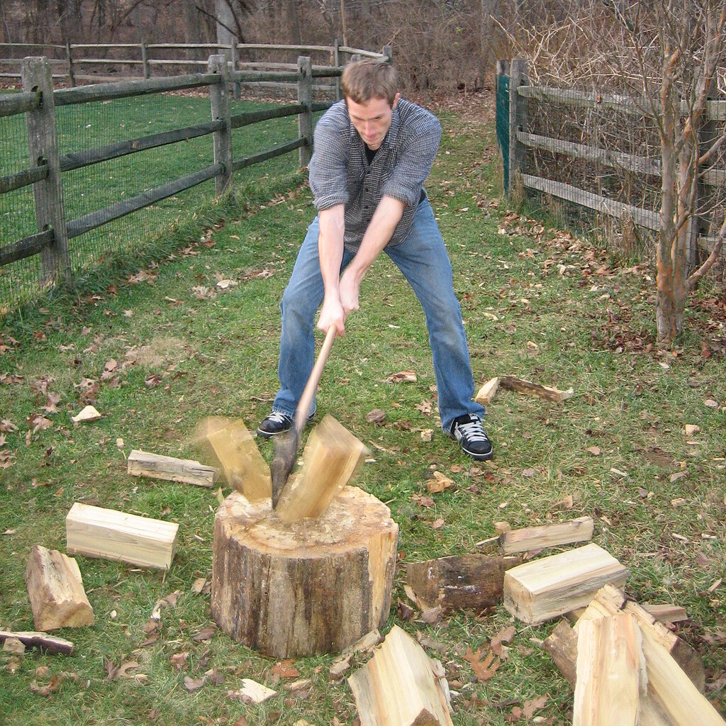 Photo of a man splitting wood