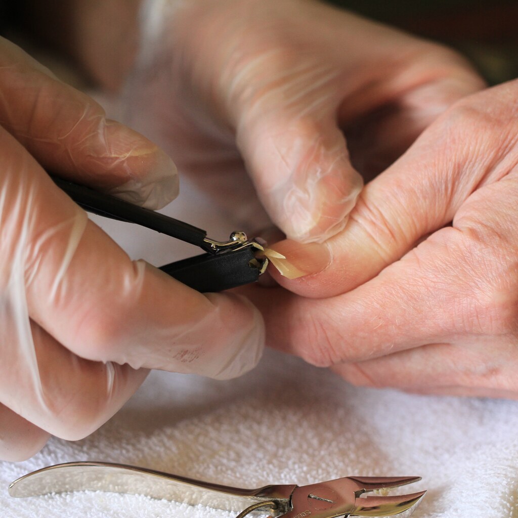 Photo of someone clipping nails