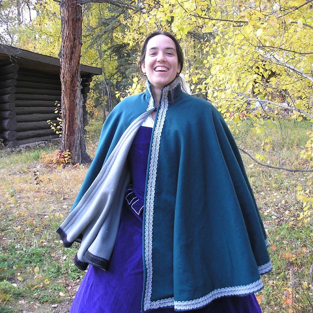Photo of a woman wearing a cloak.