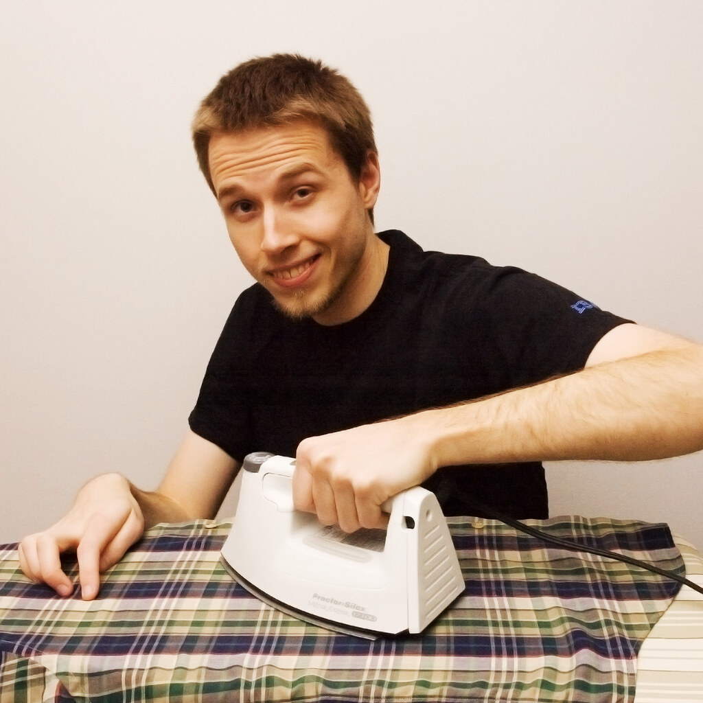 Photo of a man ironing clothes