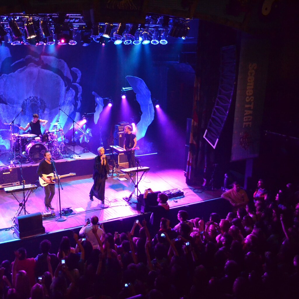 Photo of a man singing at a concert