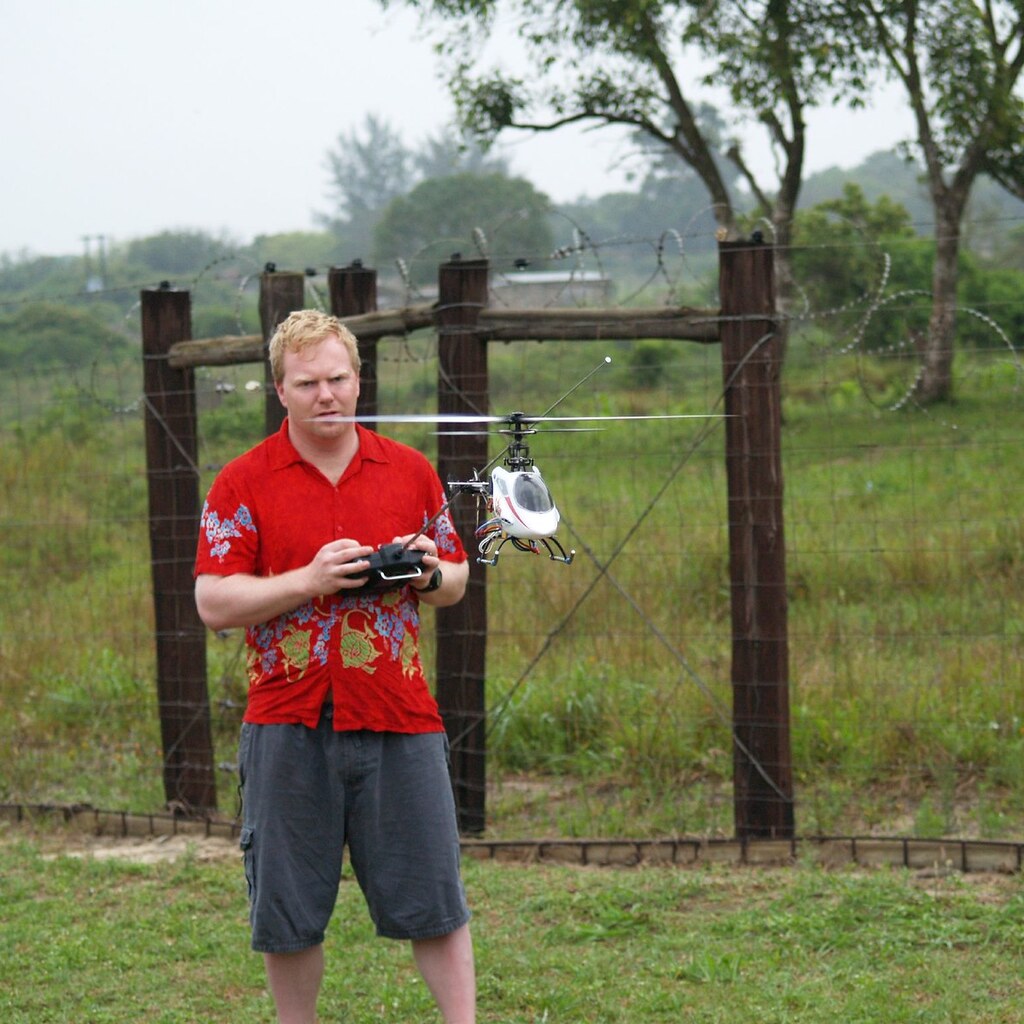 Photo of a man flying a remote control helicopter