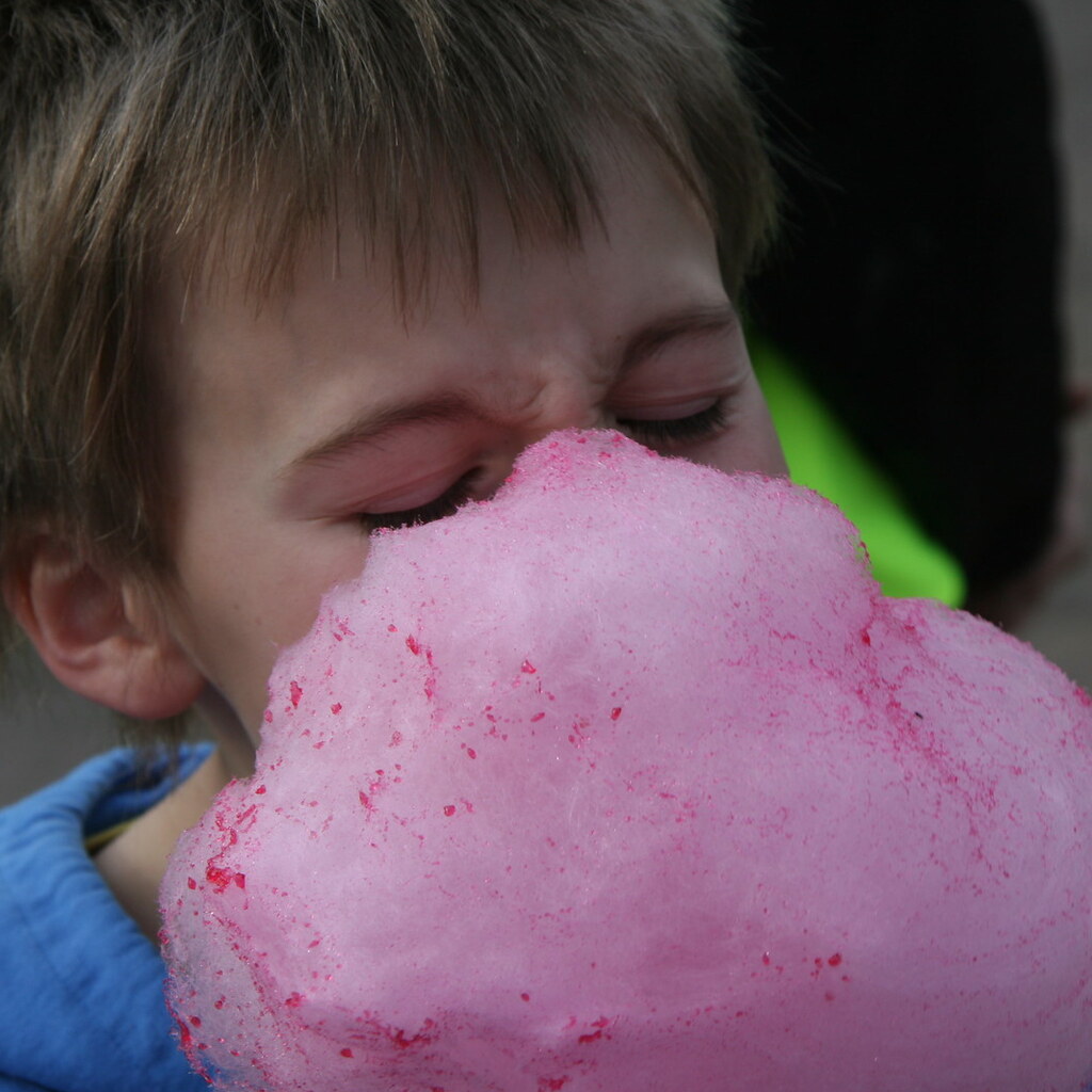 Photo of a boy eating cotton candy