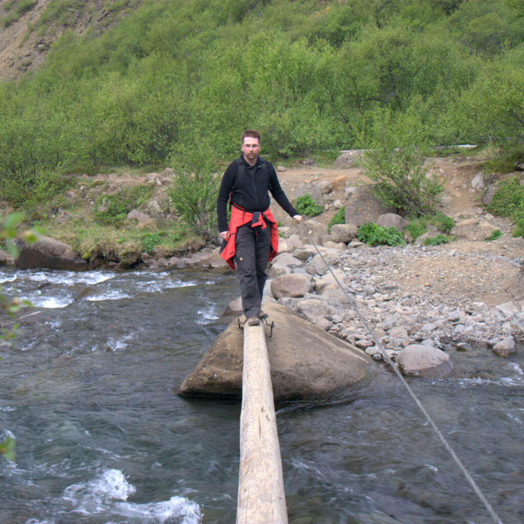 Photo of a man crossing a dangerous bridge