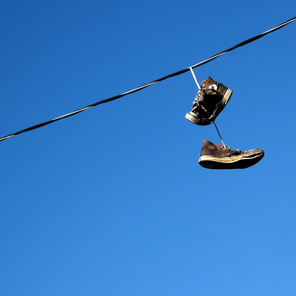 Photo of dangling shoes on a power line
