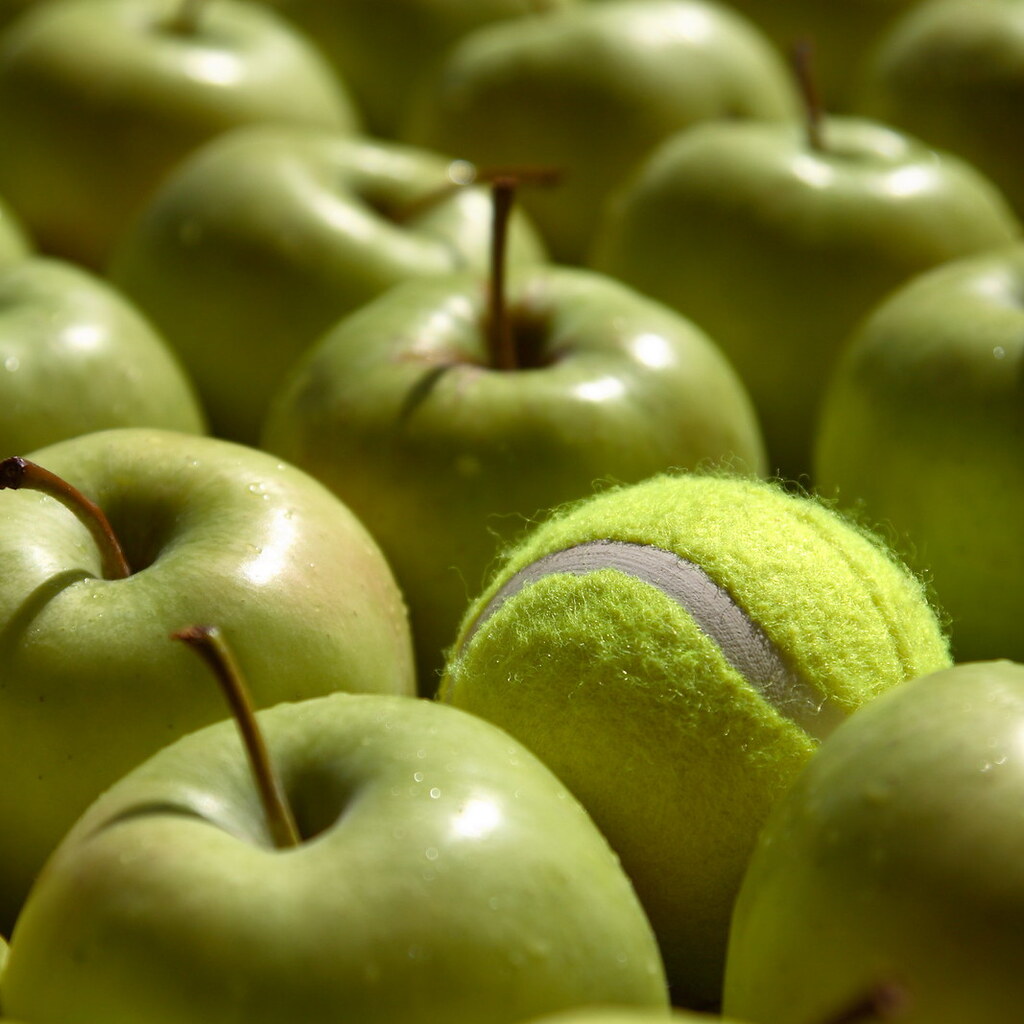 Photo of a tennis ball pretending to be an apple