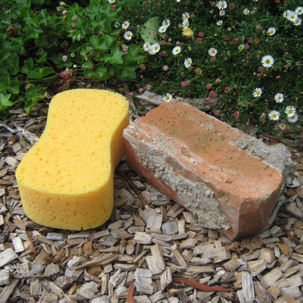 Photo of a brick and a sponge.