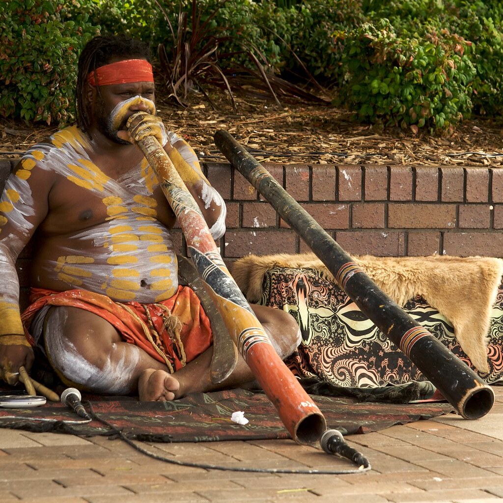 Photo of an Aboriginal playing a didgeridoo.