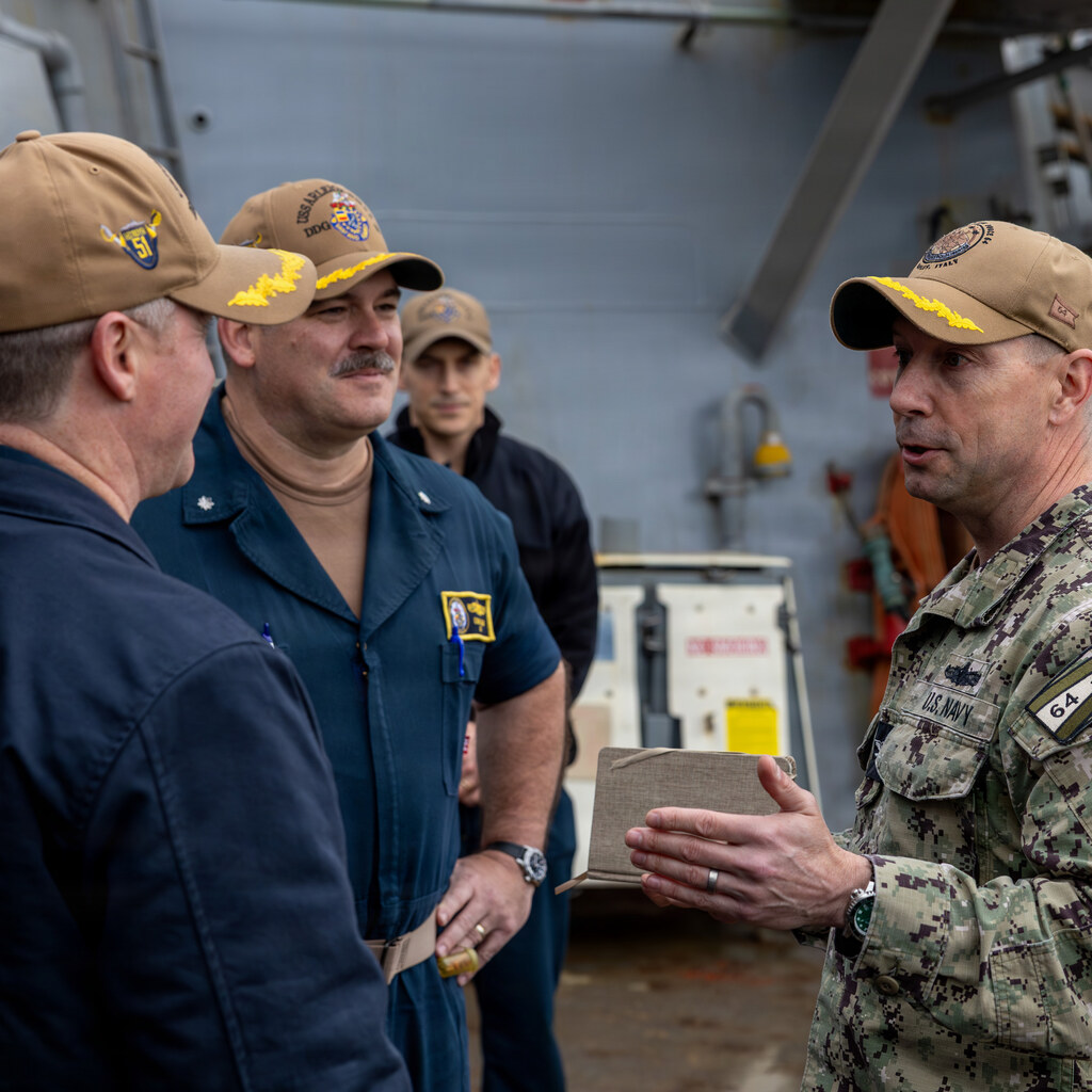 Photo of some men in the army having a discussion