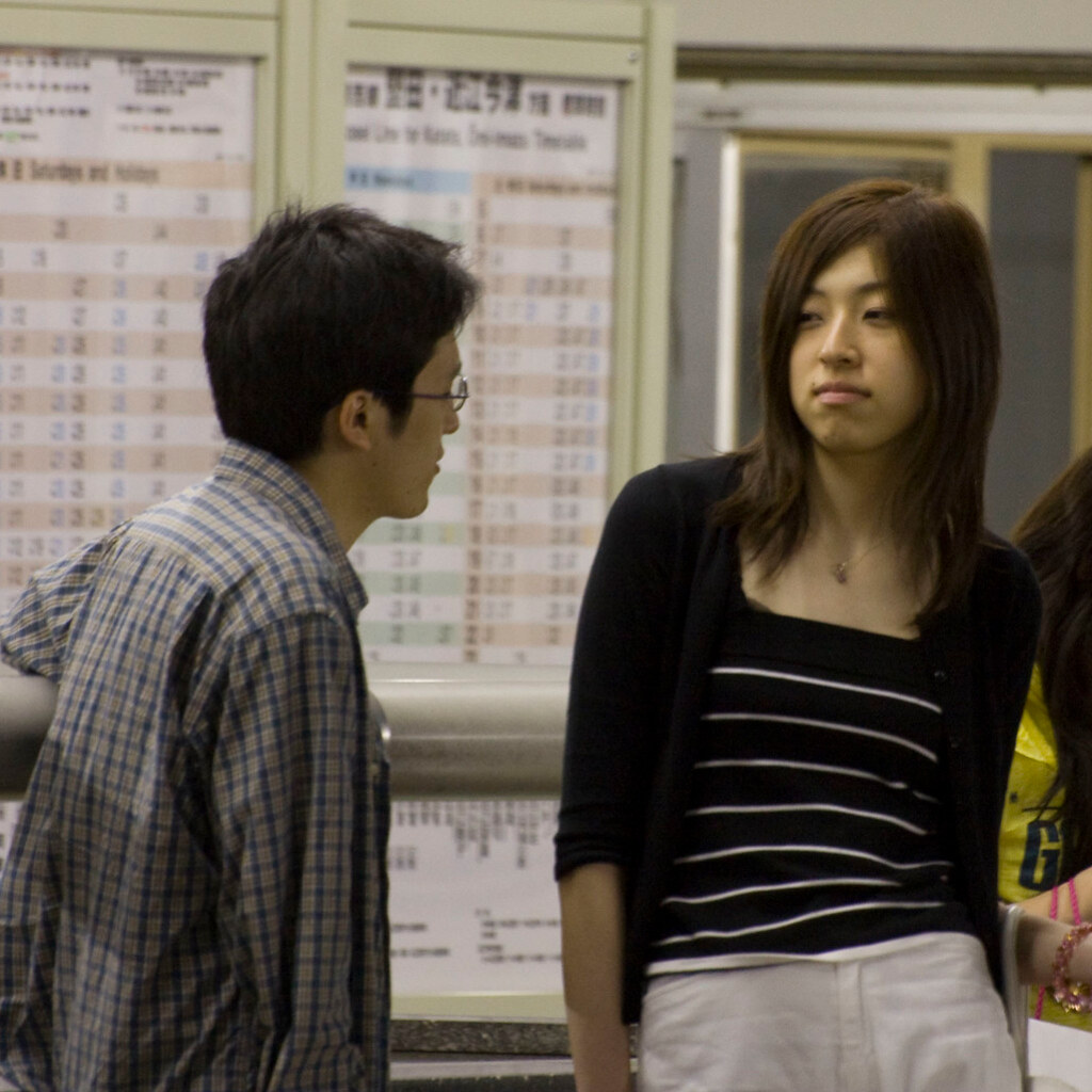 Photo of a woman looking at a man with disdain