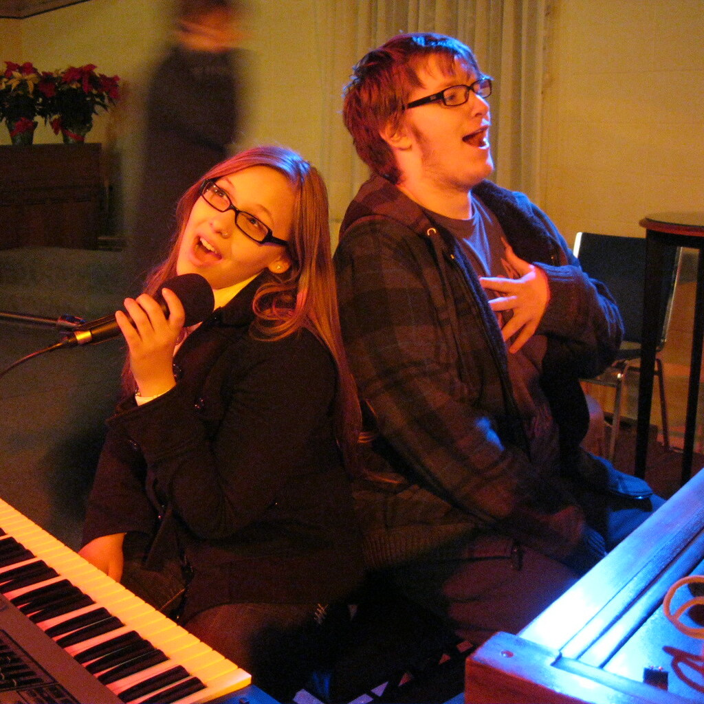 Photo of two people singing a duet