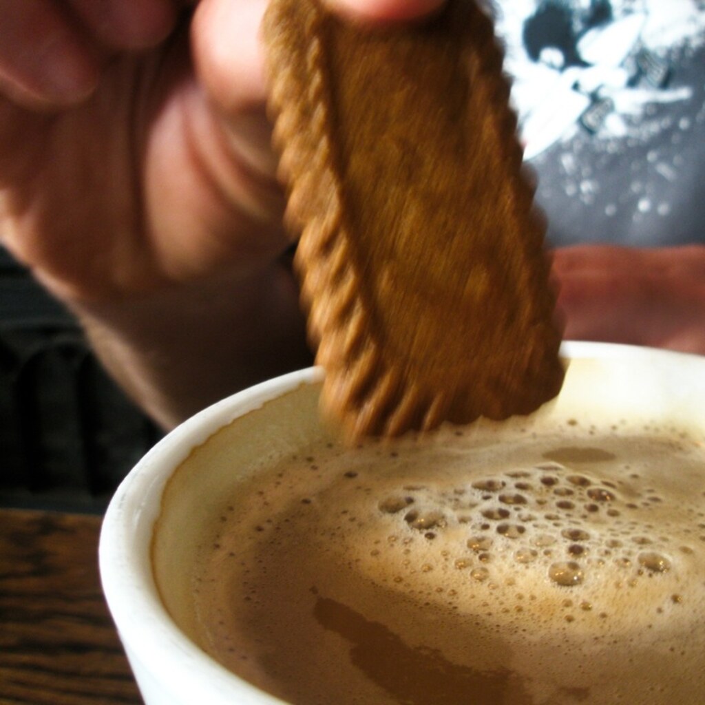 Photo of someone dunking a cookie into coffee