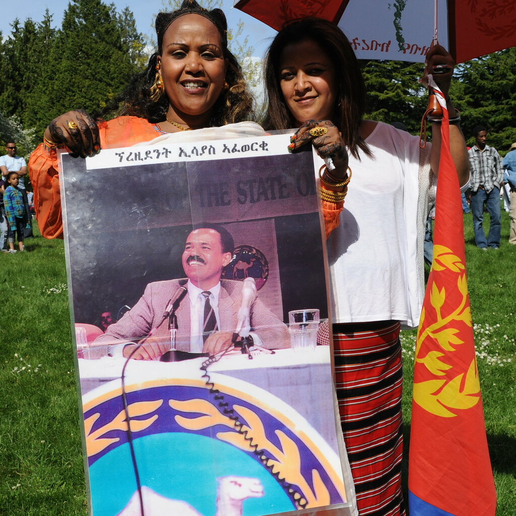 Eritreans holding the flag of Eritrea.
