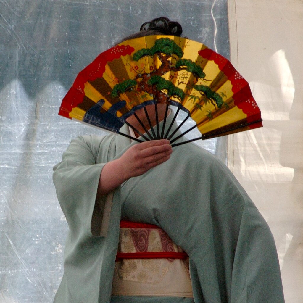 Photo of a woman holding a fan