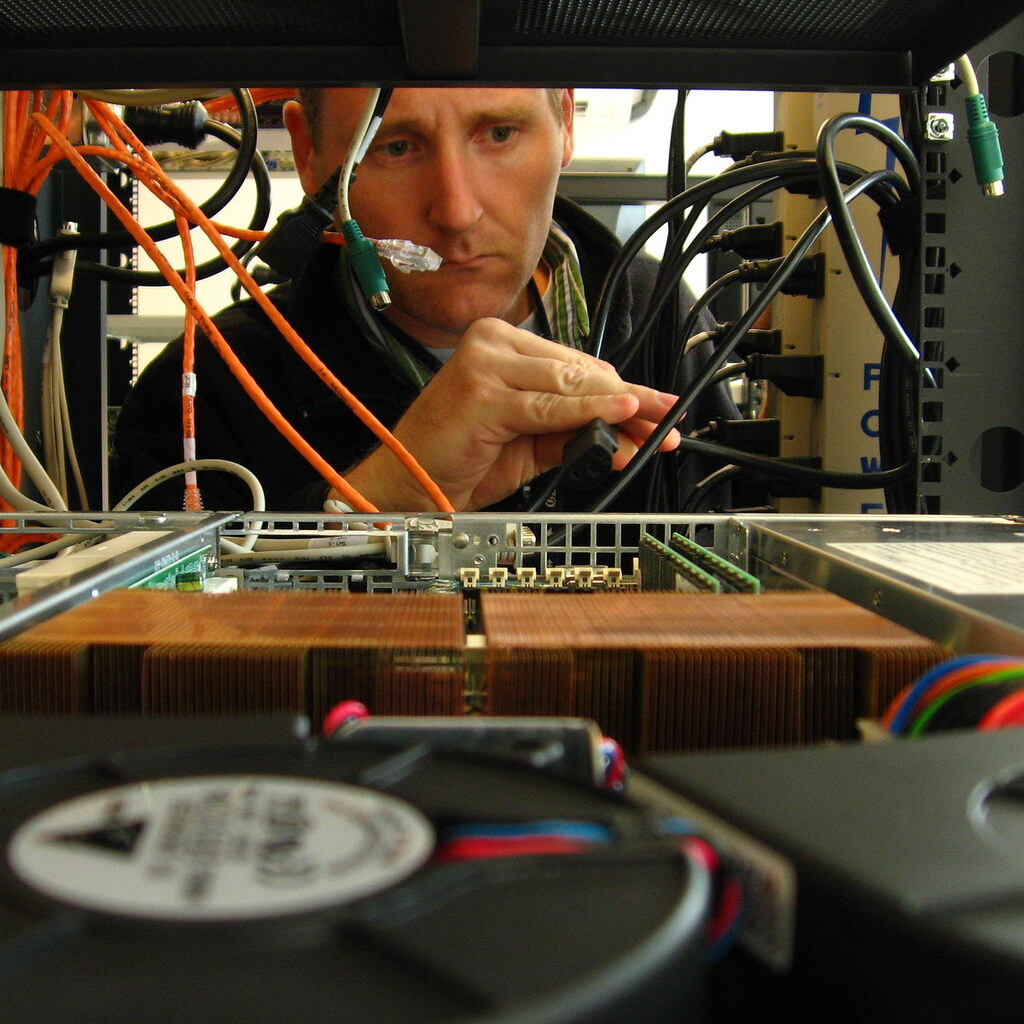 Photo of someone fixing a computer