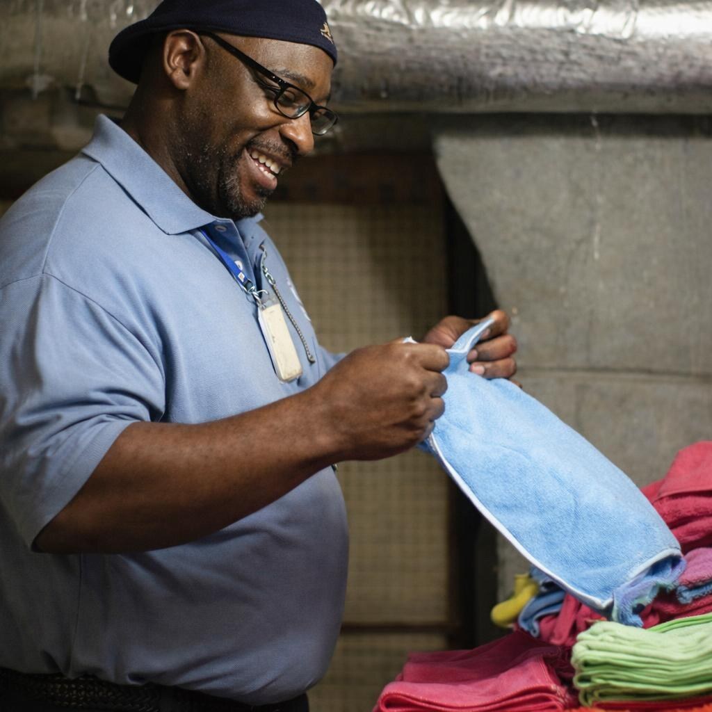 Photo of a man folding clothes.