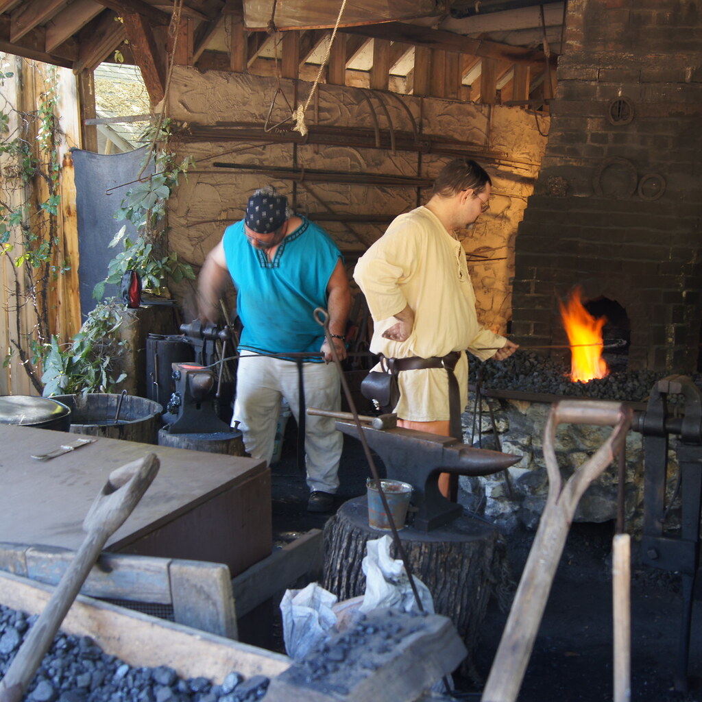 Photo of a blacksmith using a forge