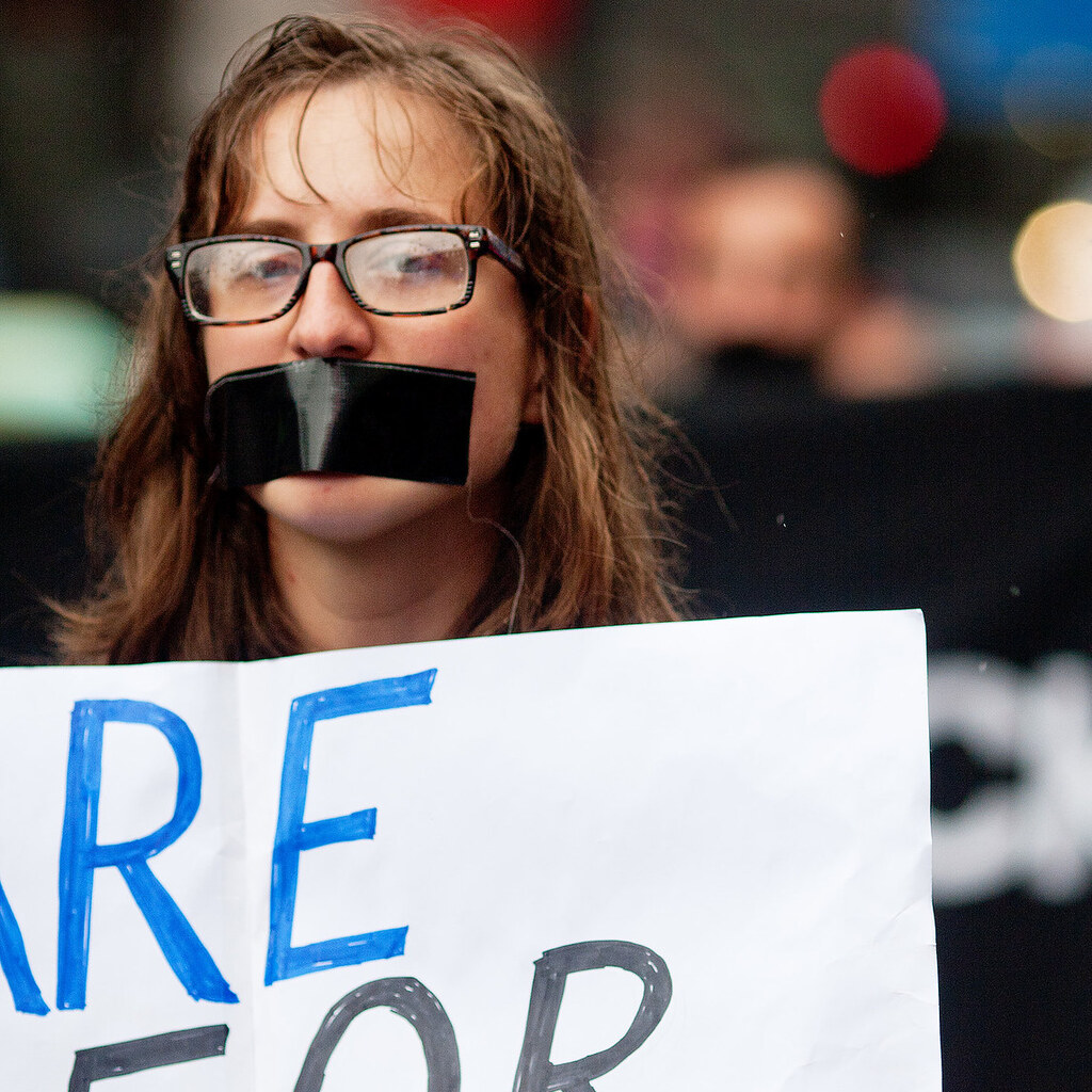 A protester wearing a gag.