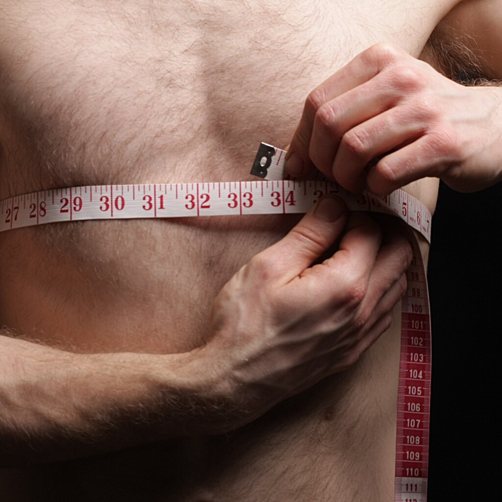 Photo of a man measuring around his chest