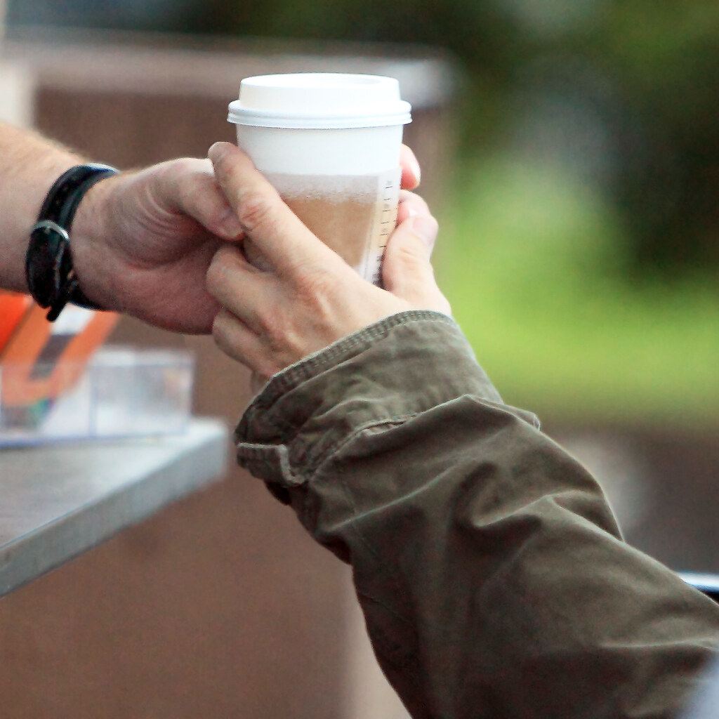 Photo of someone giving a coffee