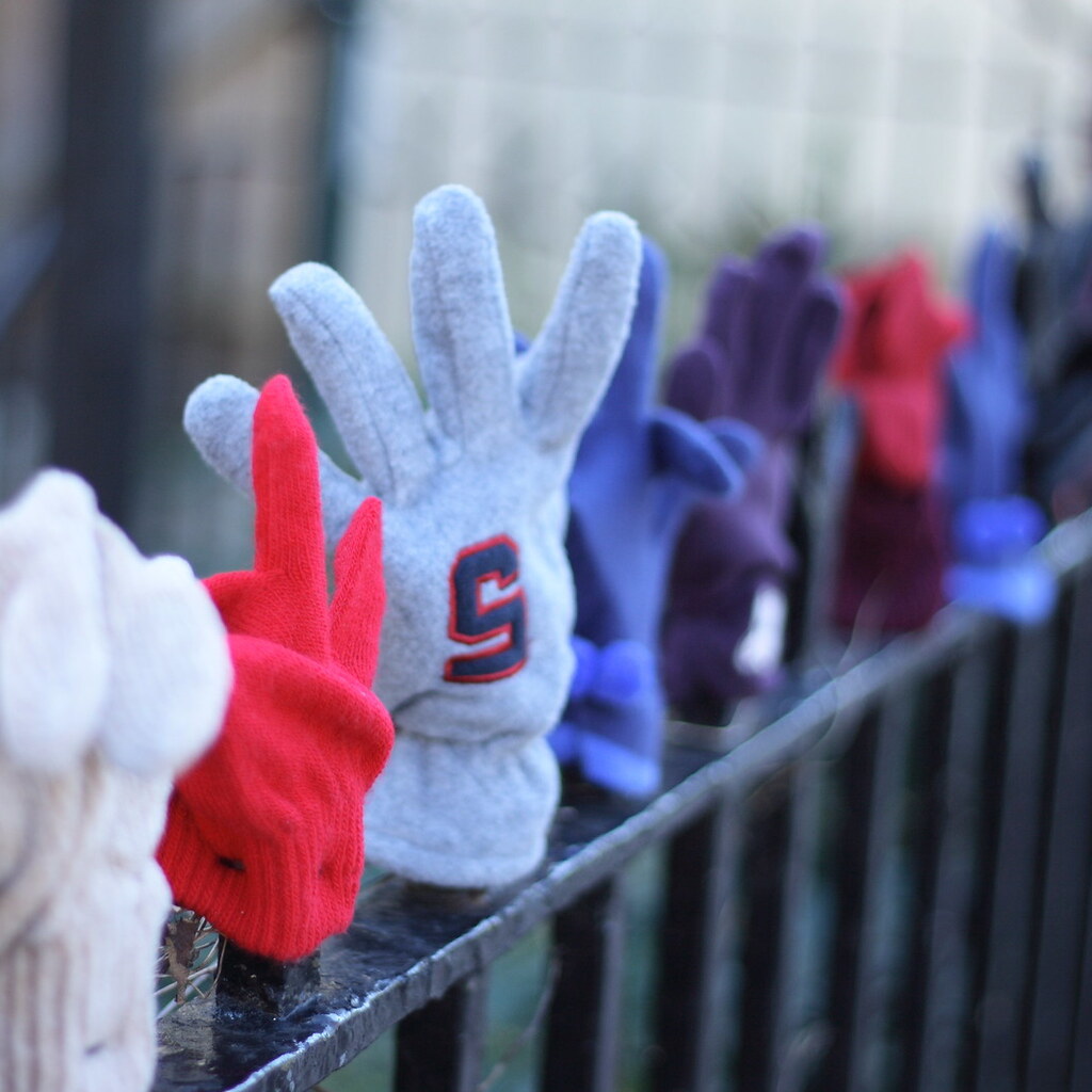 Photo of gloves on a fence.