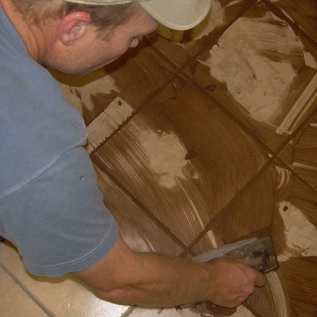 Photo of a man spreading grout