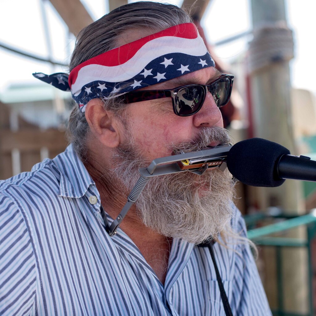Photo of a man playing a harmonica