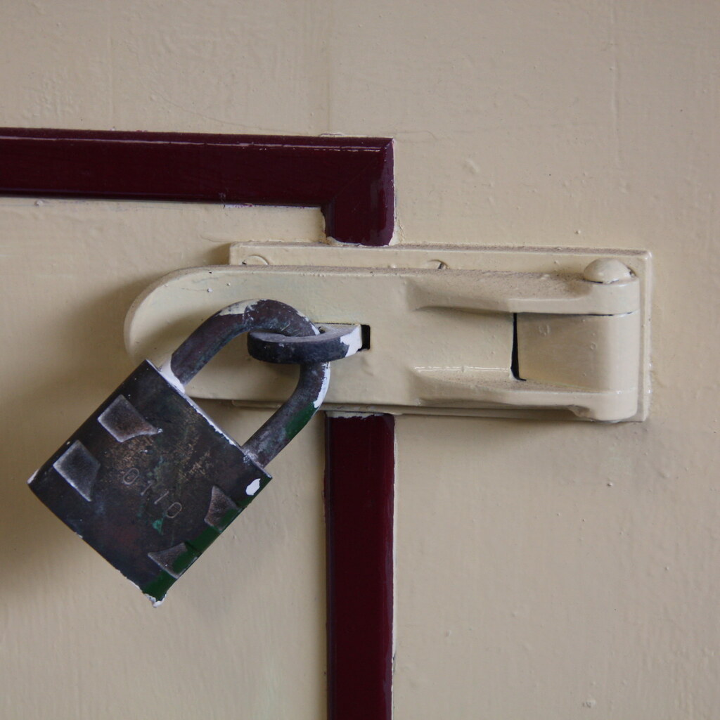 A hasp fitted with a lock.