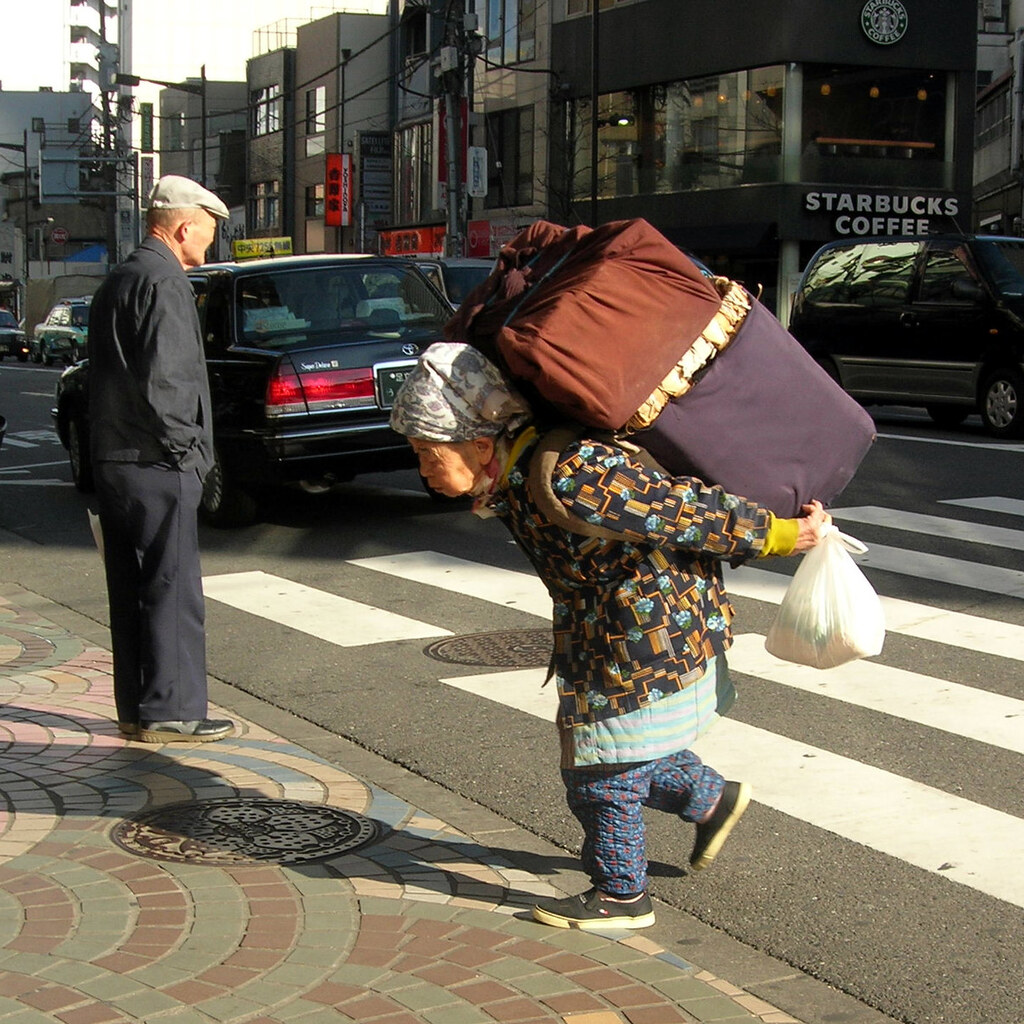 Photo of a woman carrying a heavy load