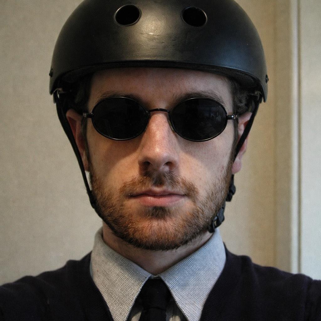 Photo of a man wearing a black helmet.