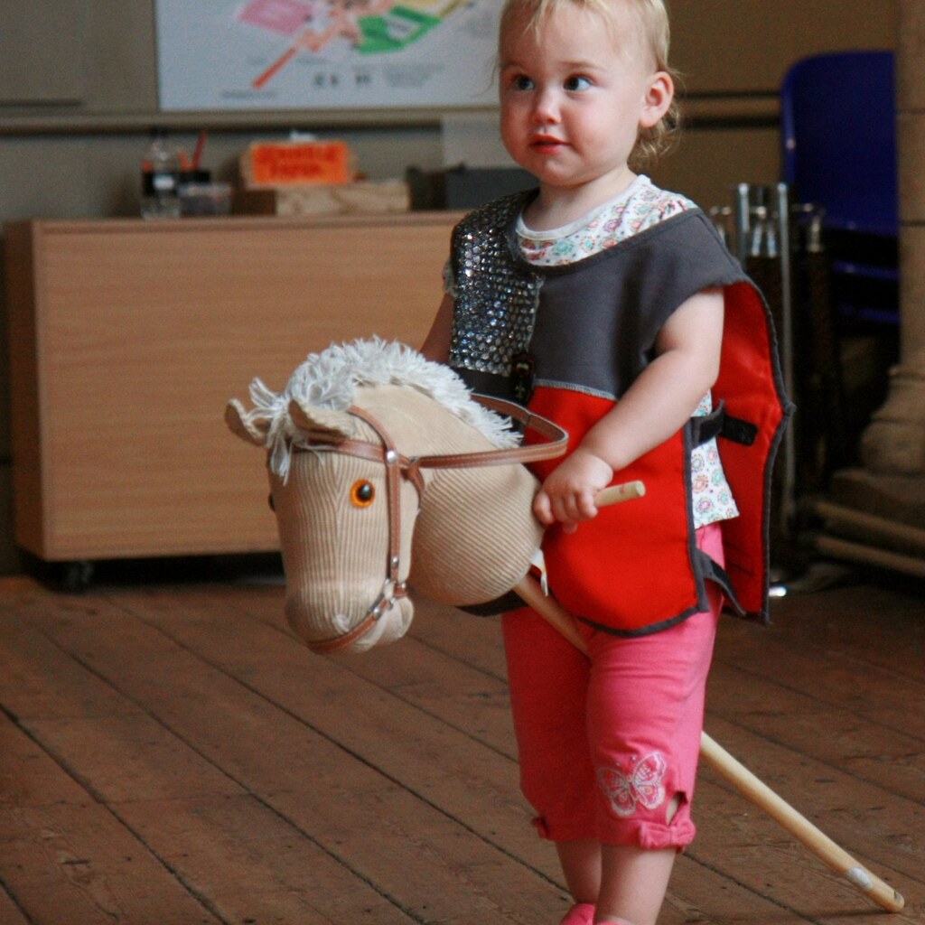 Photo of a toddler riding a hobby horse