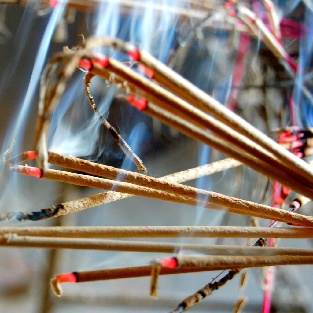 Photo of incense sticks burning.