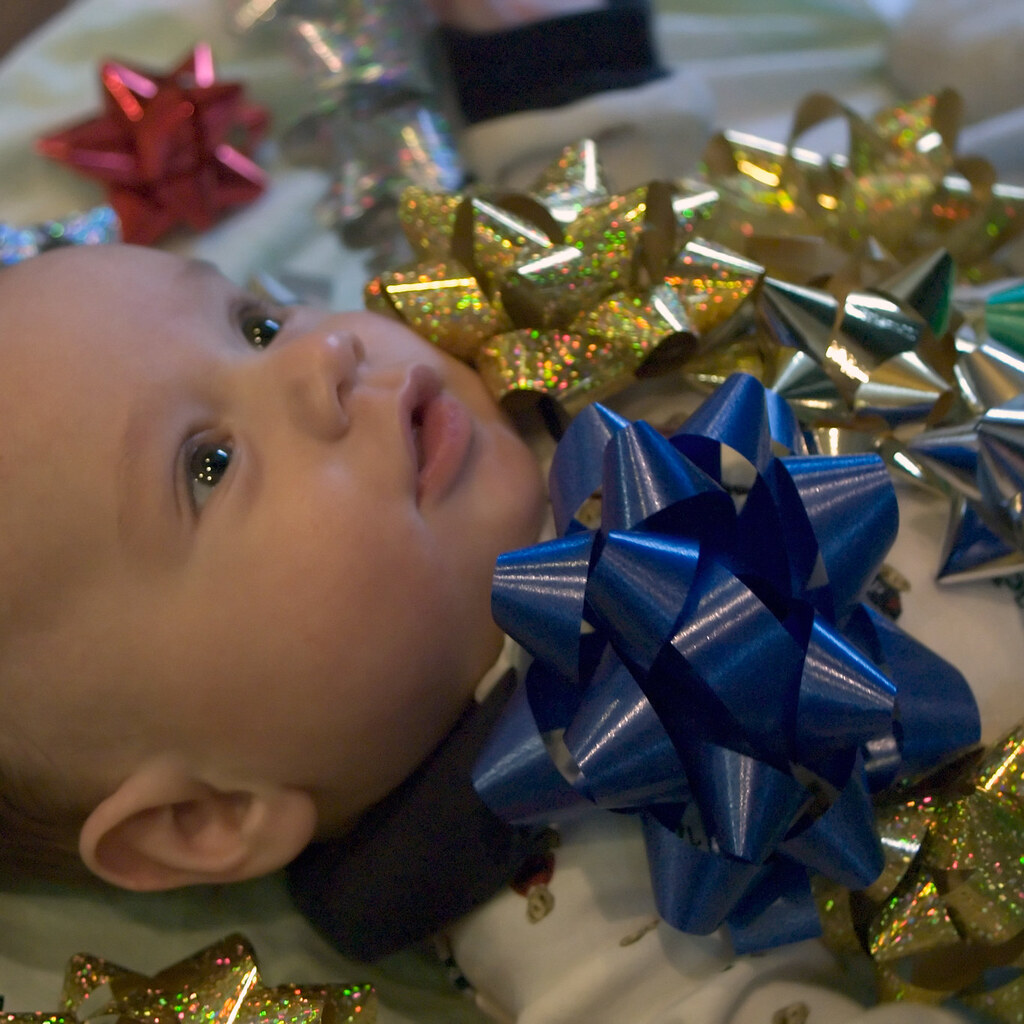 Photo of a baby covered in bows