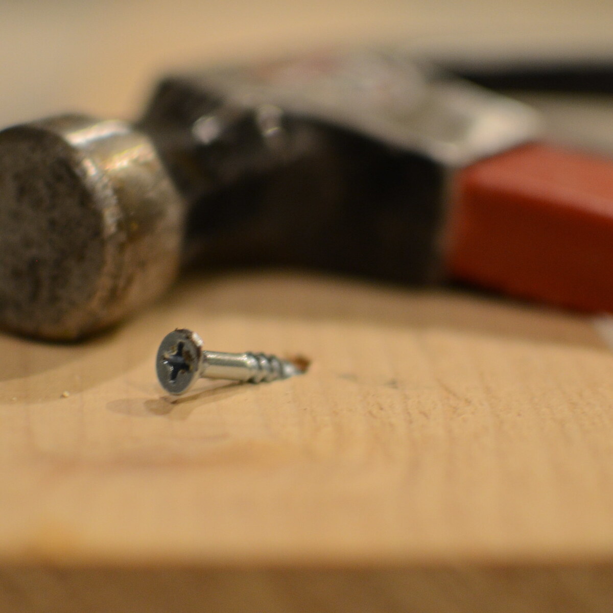 Photo of a hammer and a screw