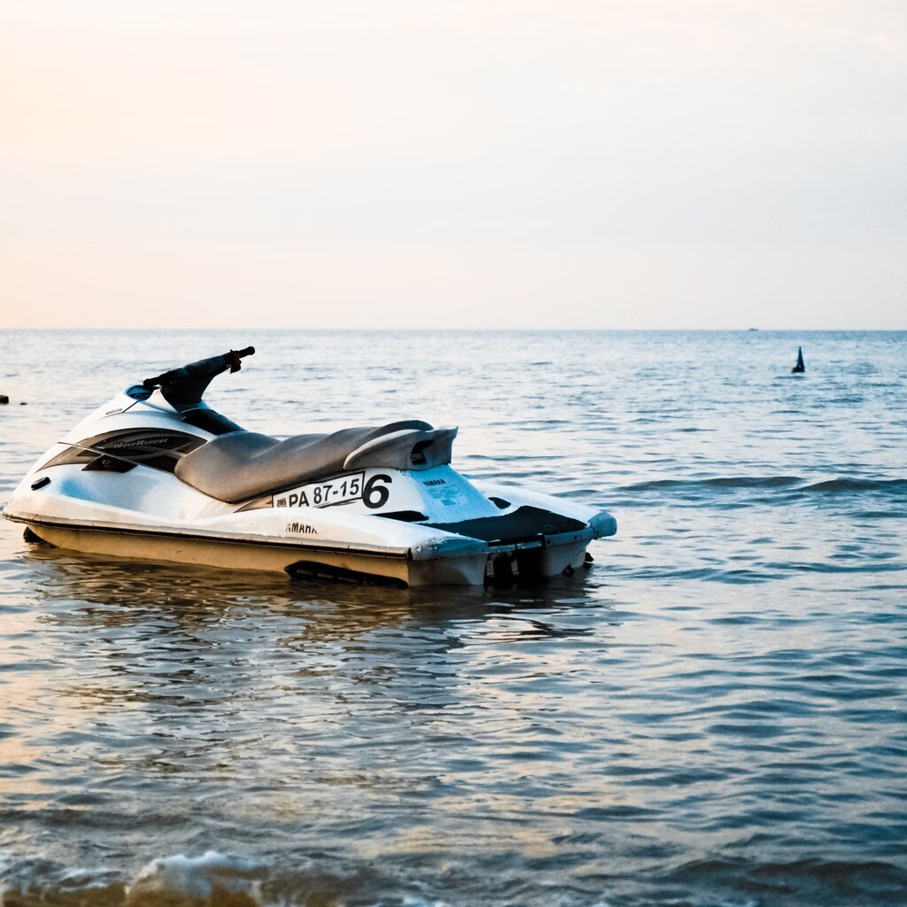 A photo of a white and black jet ski floating on calm water.