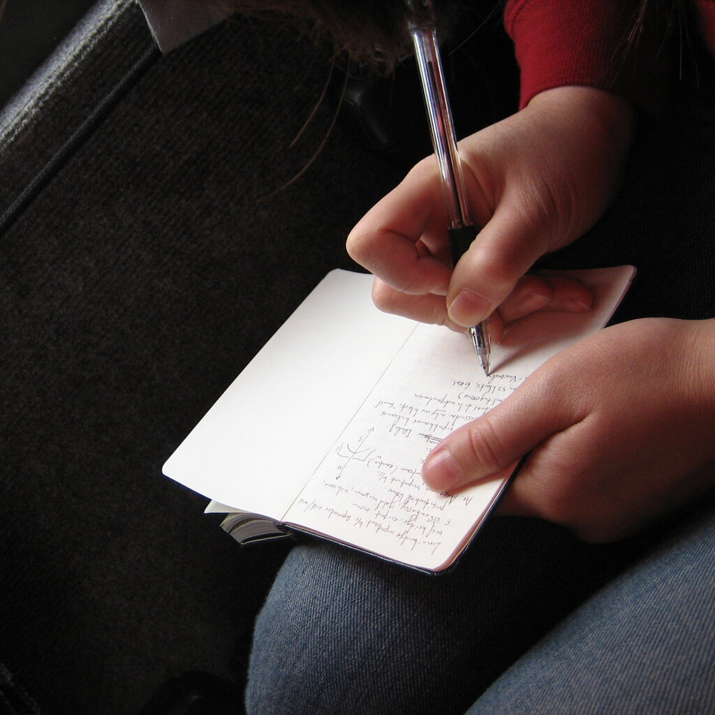 Photo of someone jotting down notes