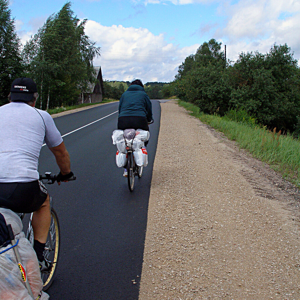 Photo of two people on a bike journey