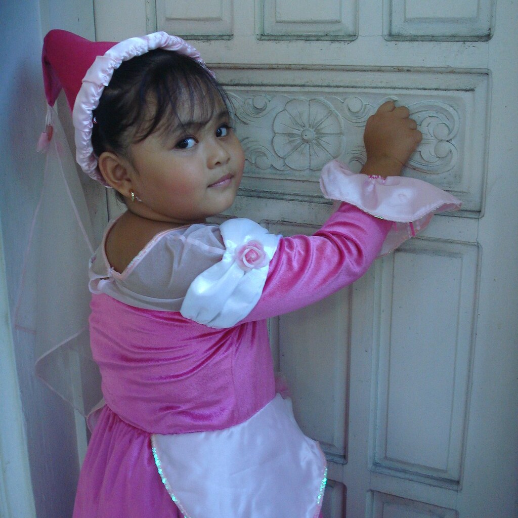 Photo of a little girl knocking on a door