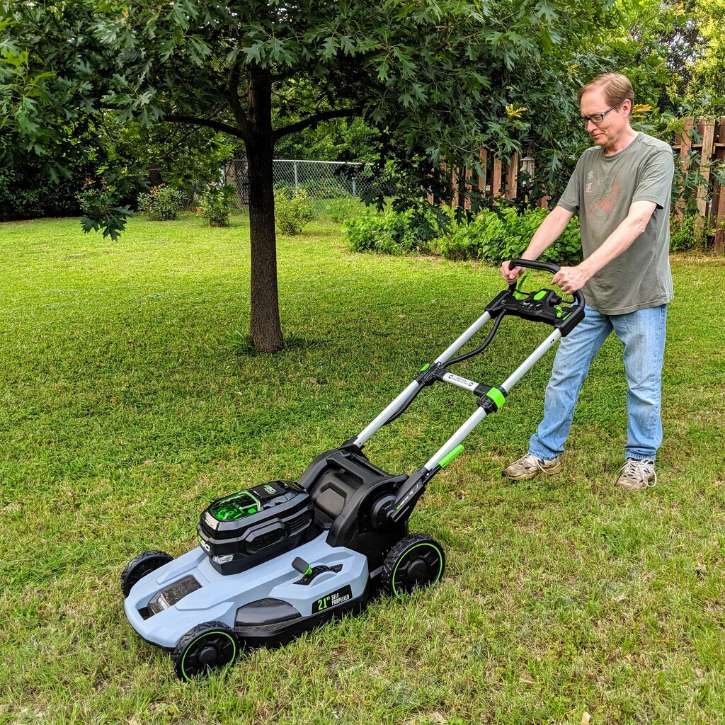 Photo of a man mowing a lawn