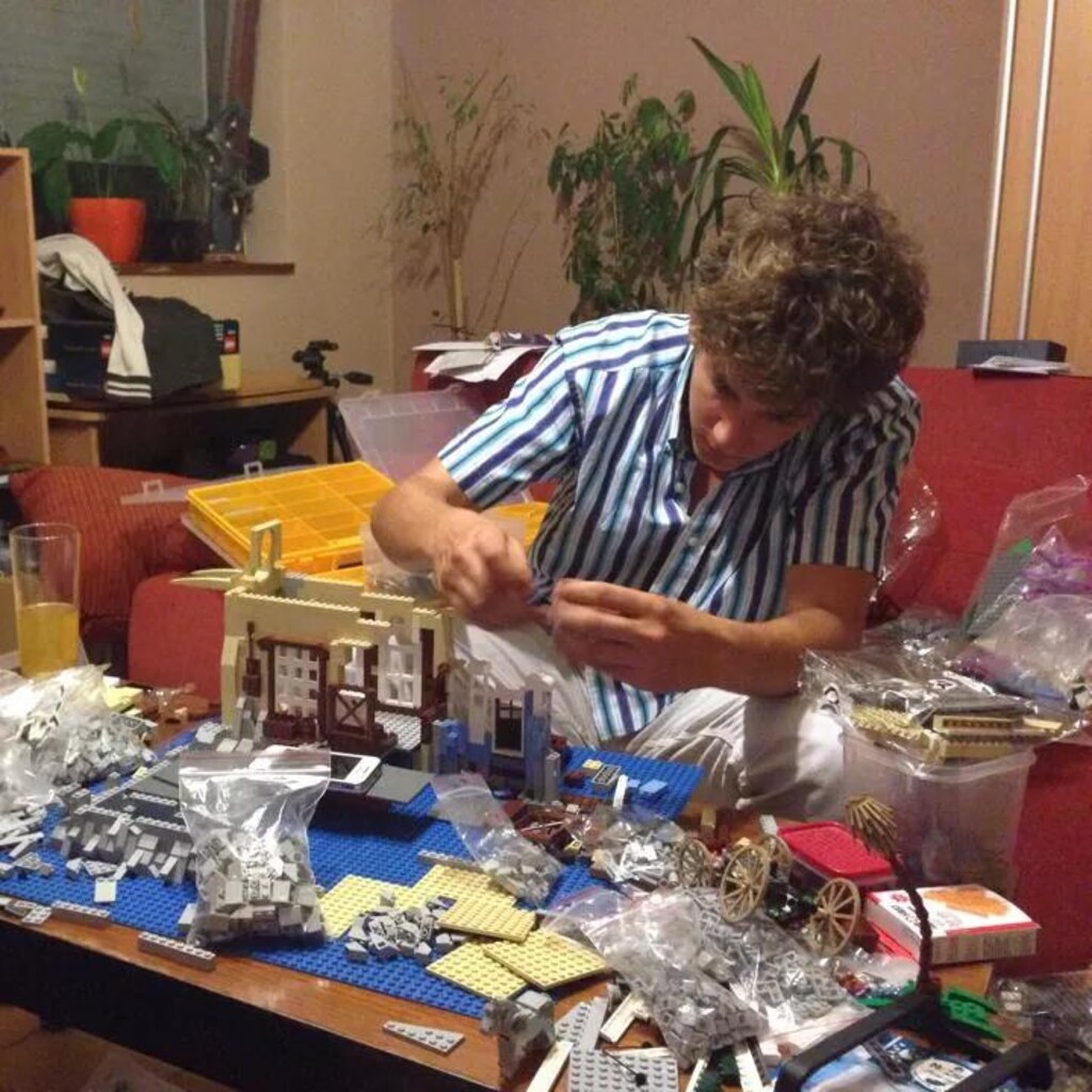 Photo of a man making some Lego models