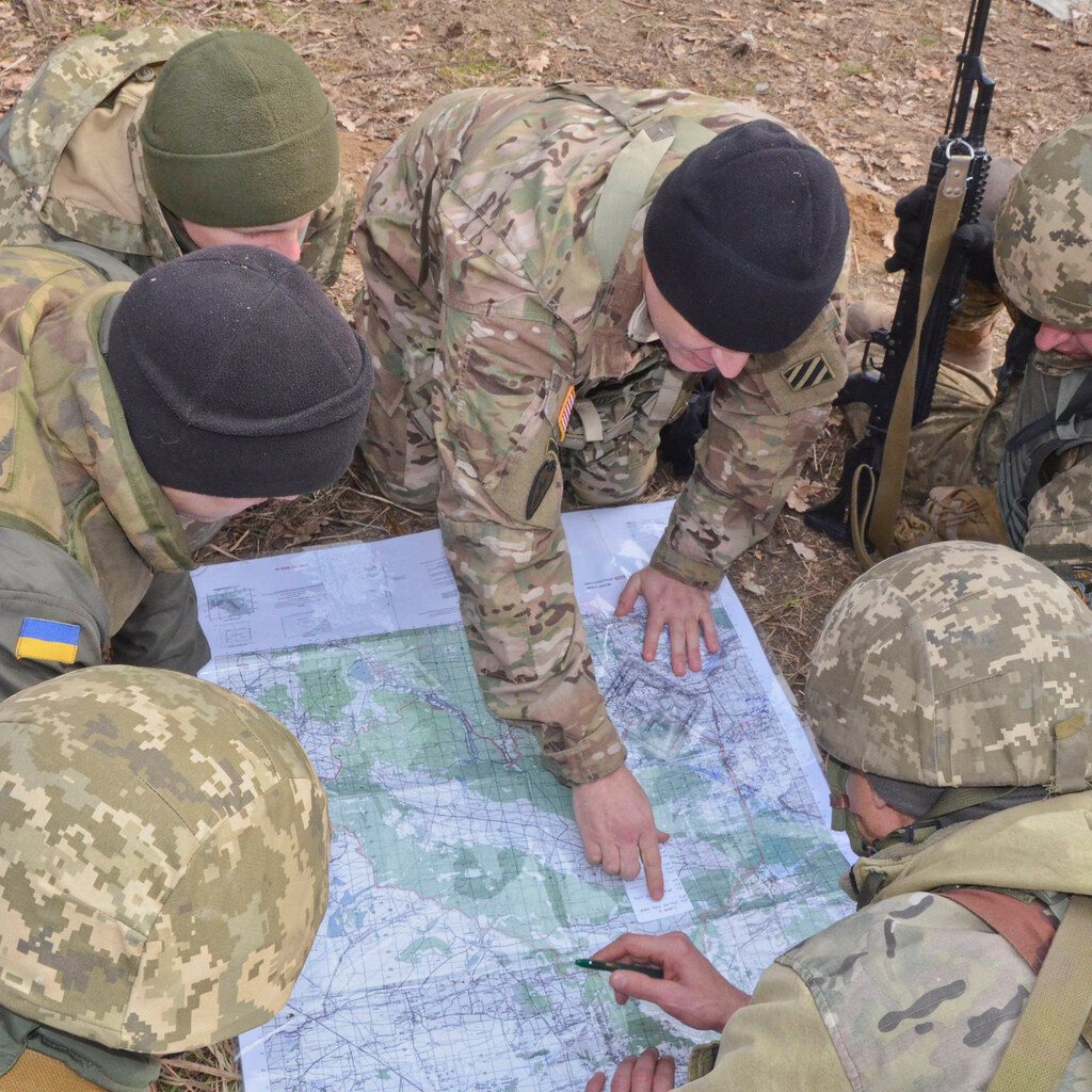 Photo of soldiers reading a map