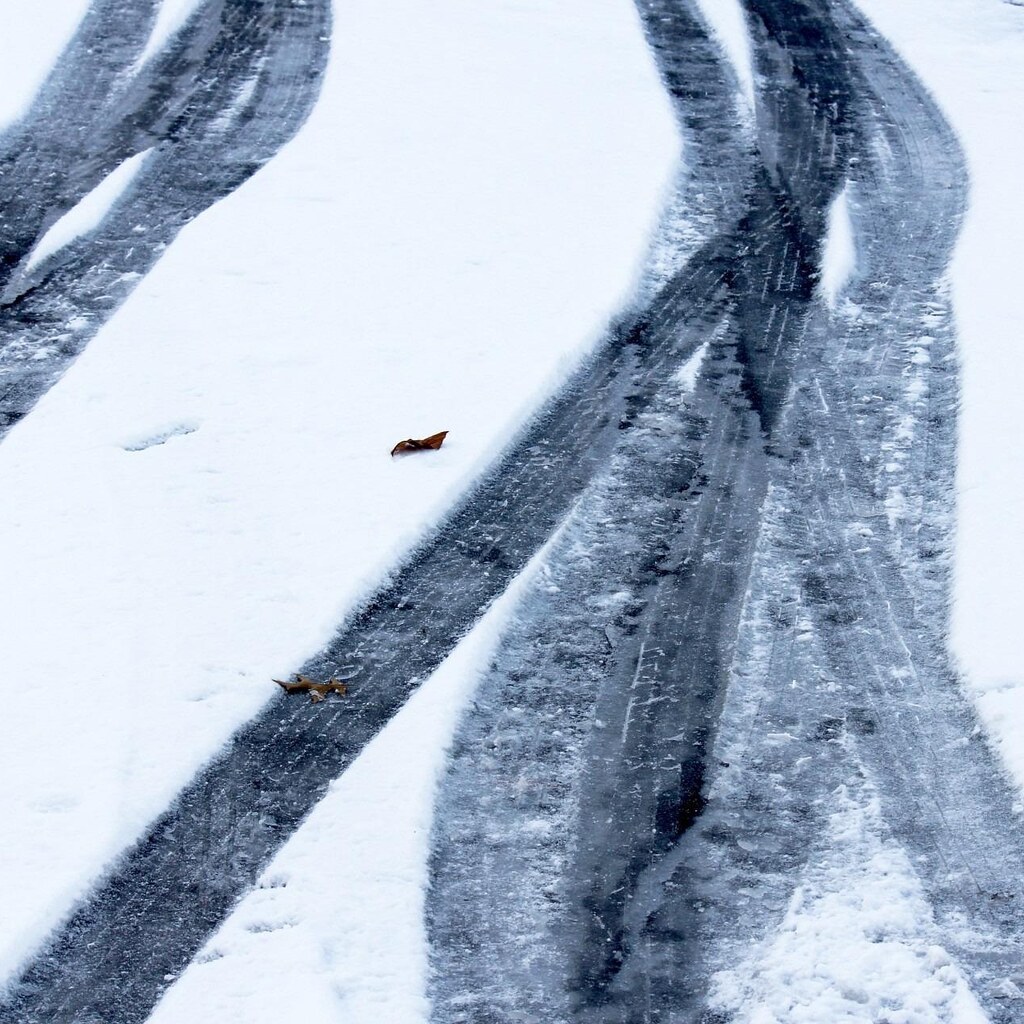 Photo of tire marks in the snow.