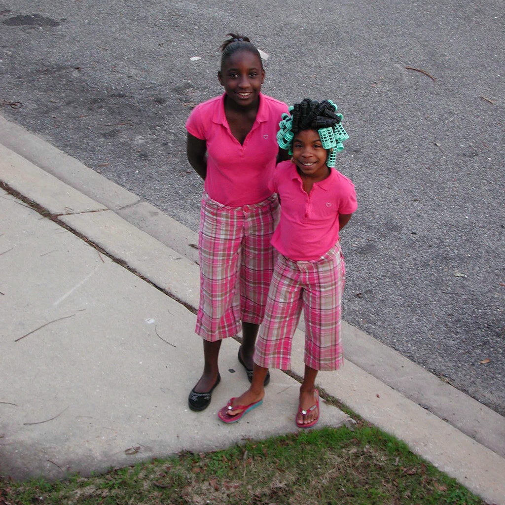 Photo of two girls in matching outfits.