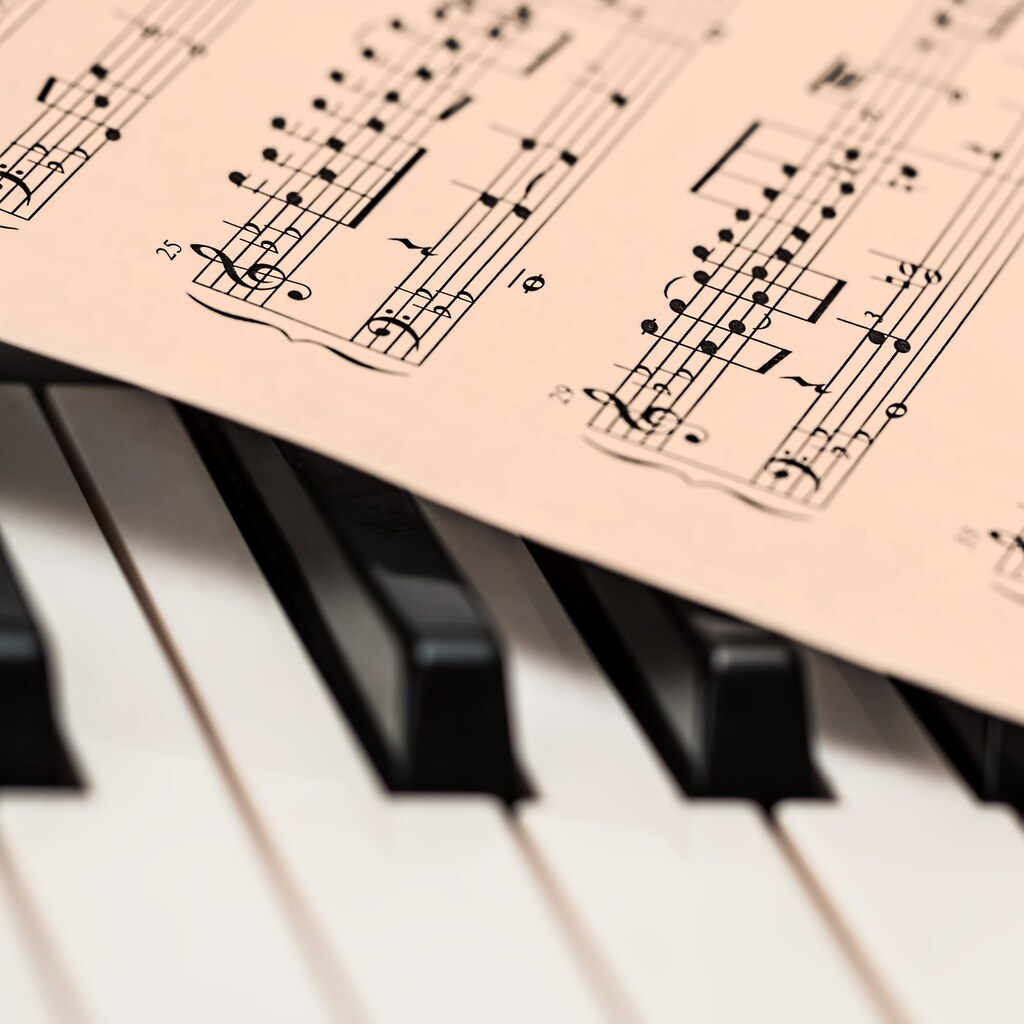Photo of sheet music and a keyboard