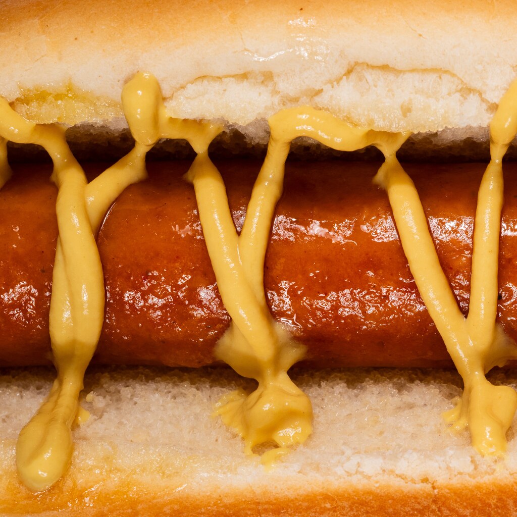 Photo of mustard sauce on a hot dog
