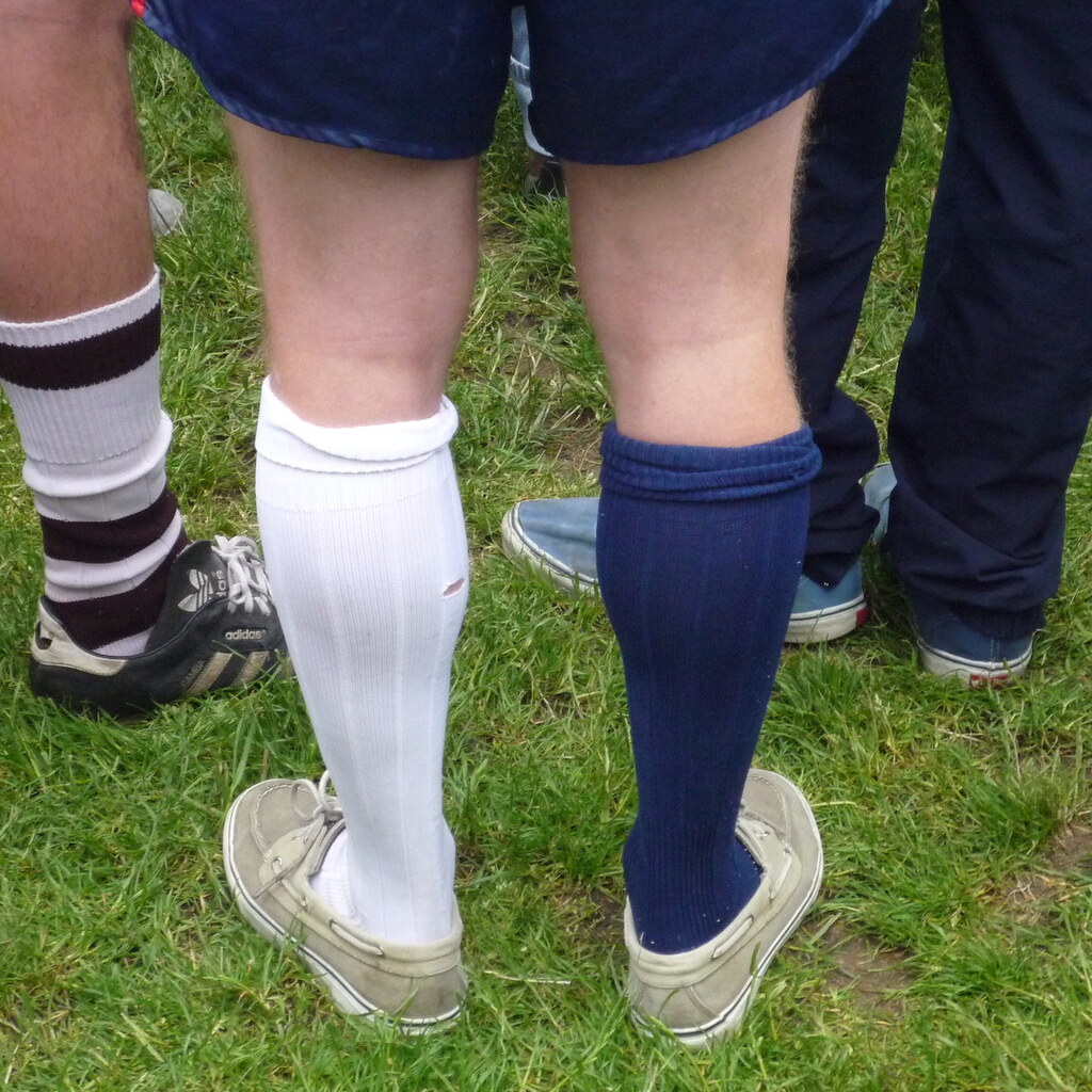Photo of a man wearing odd socks