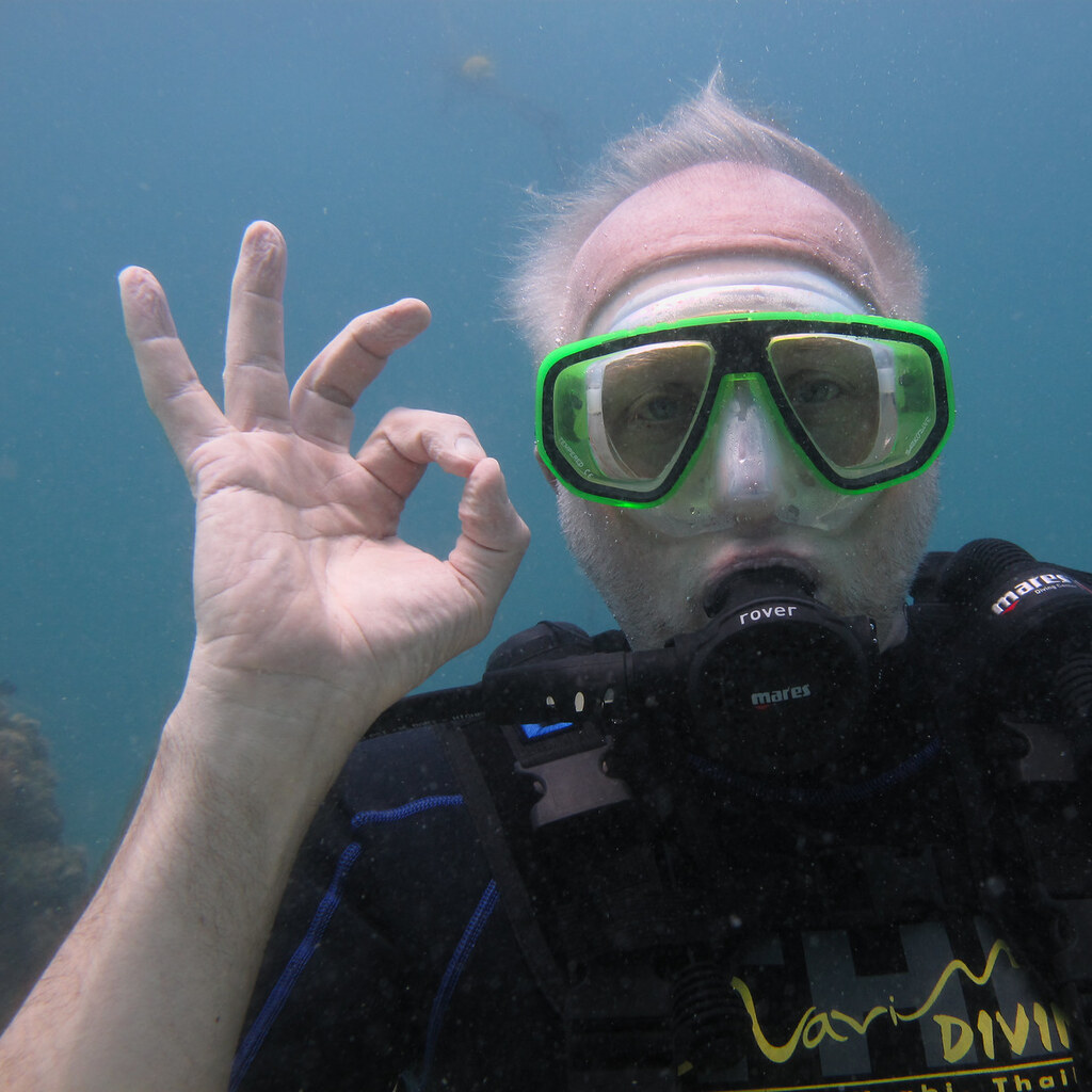 Photo of a man making an ok hand signal