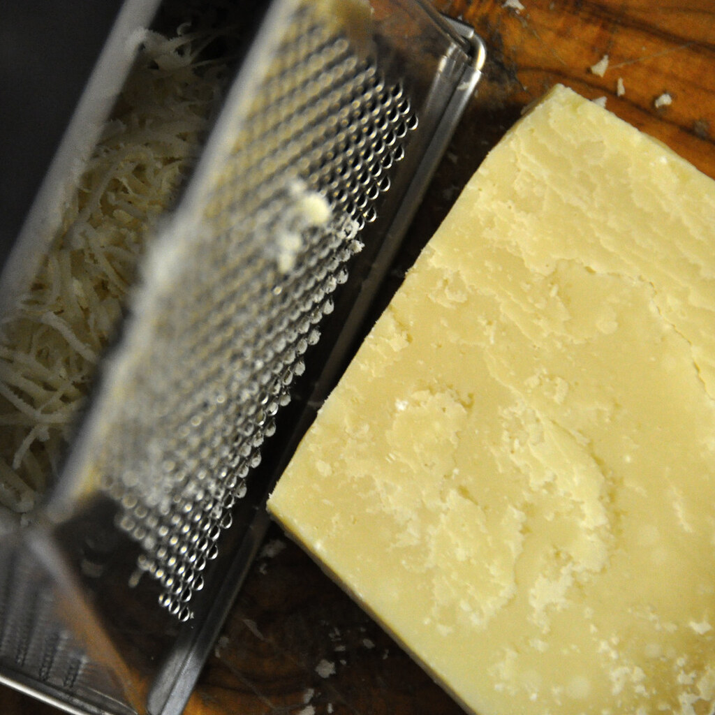 Photo of parmesan cheese being grated.