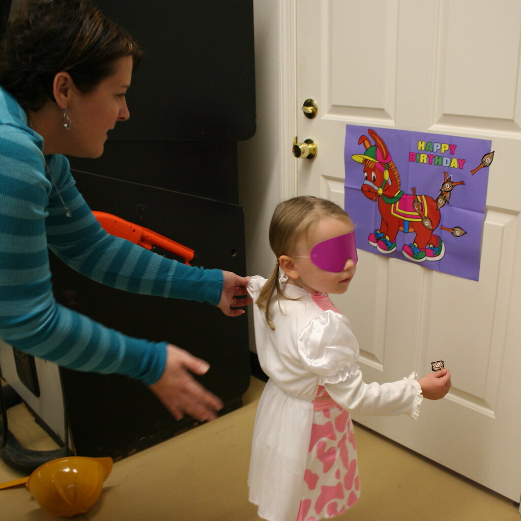 Photo of a child playing pin the tail on the donkey